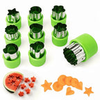 Stainless steel cookie cutter molds in green plastic holders, stacked with shaped fruit pieces